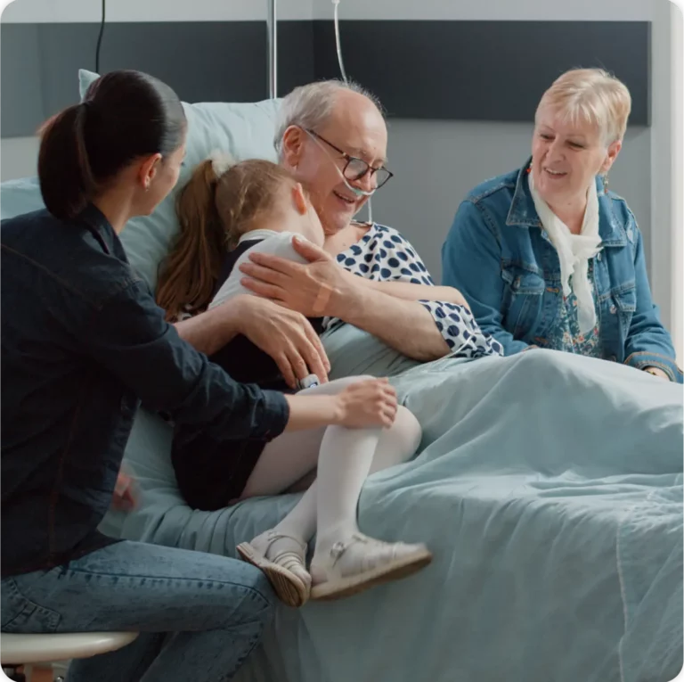 Child hugging sick grandpa in hospital ward bed at visit post icu